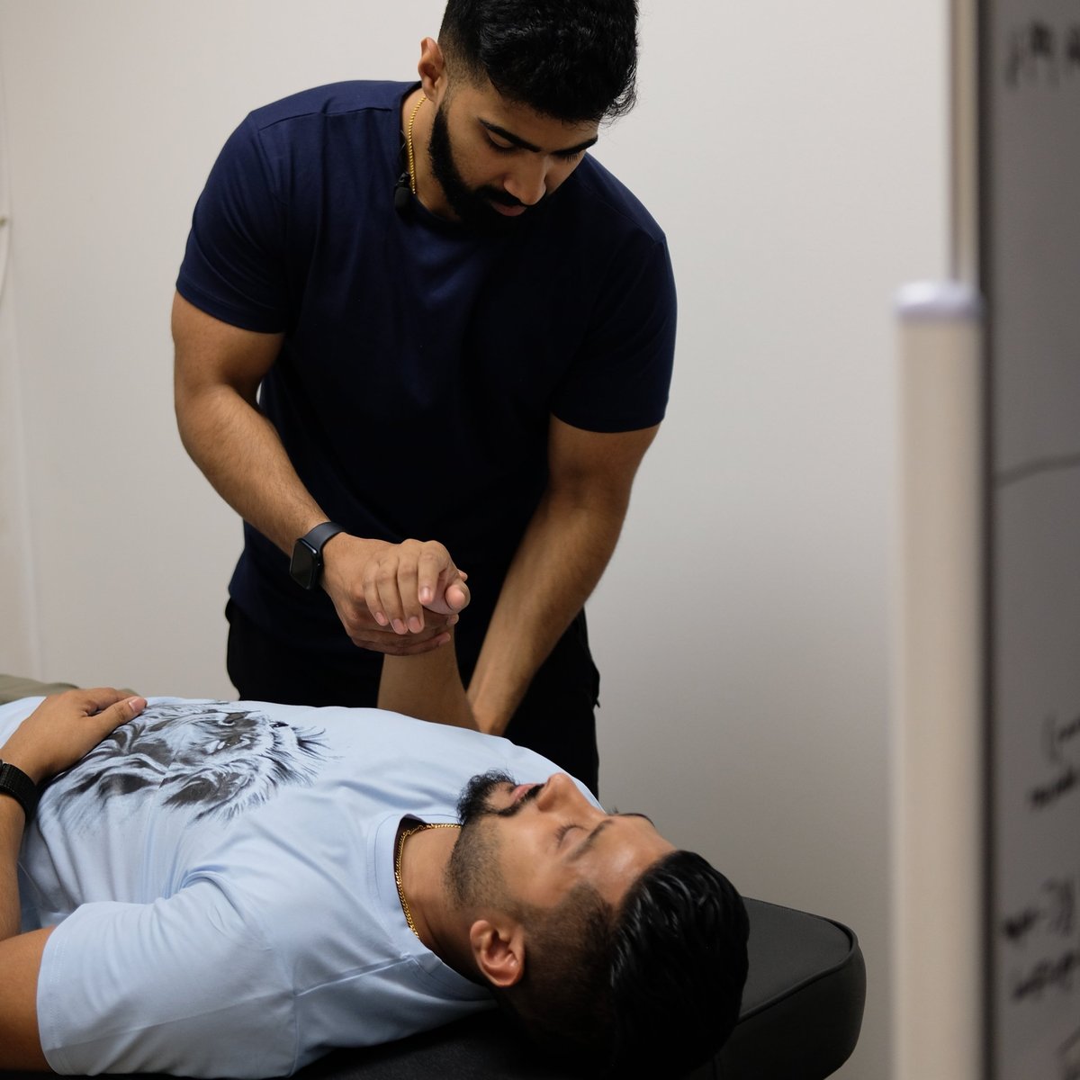 Dr. Nevin Saju working one-on-one with a patient